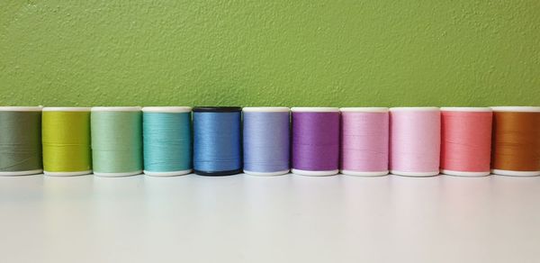 Close-up of colorful spools on table