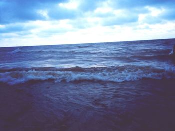Scenic view of sea against cloudy sky