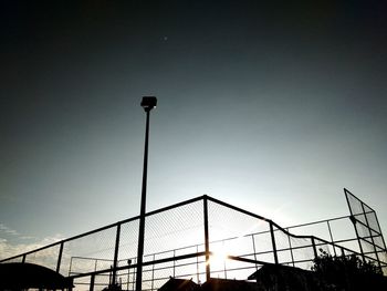 Low angle view of silhouette street light against sky