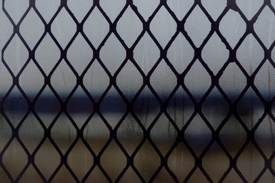 Full frame shot of chainlink fence against sky