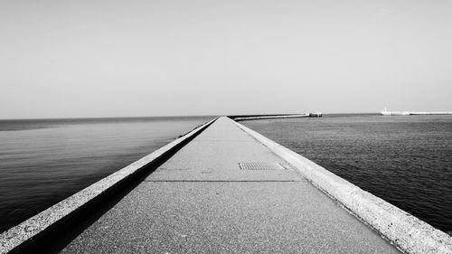 Empty road along calm sea