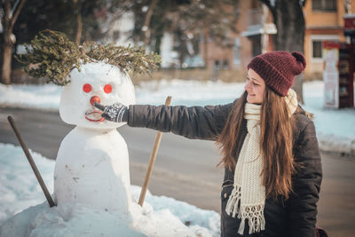 Woman wearing hat against snow during winter