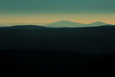 Scenic view of silhouette mountains against sky at sunset