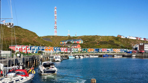 Boats in river with buildings in background