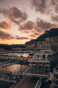 High angle view of buildings against cloudy sky during sunset