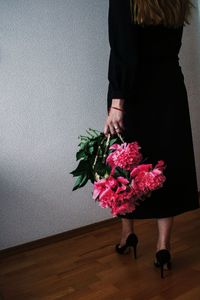 Rear view of woman holding flower bouquet