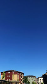 Low angle view of buildings against blue sky