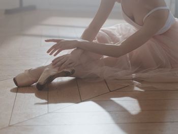 Low section of woman sitting on floor