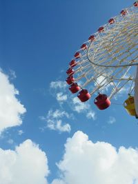 Low angle view of ferris wheel against blue sky