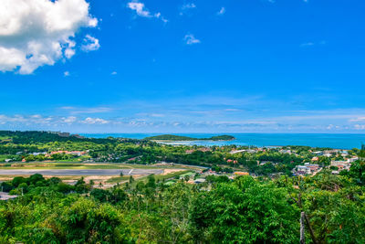 Scenic view of townscape against blue sky