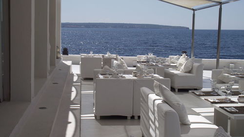 Place setting at resort against sea