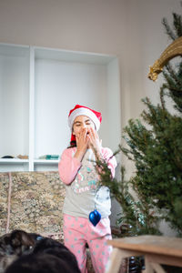 Portrait of boy playing with teddy bear at home