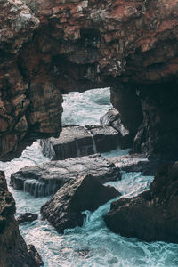 Low angle view of river flowing through cave