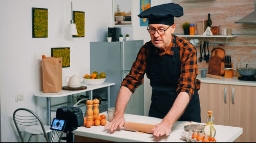 Portrait of woman standing in kitchen