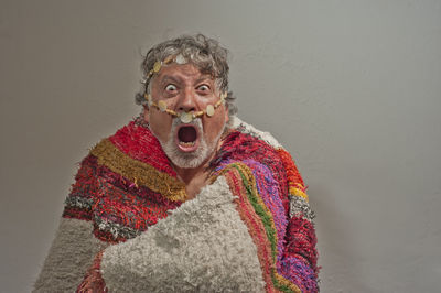 Portrait of man wearing mask against gray background