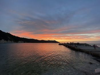 Scenic view of beach against sky during sunset