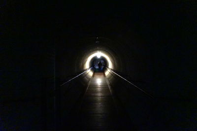 Low angle view of illuminated tunnel