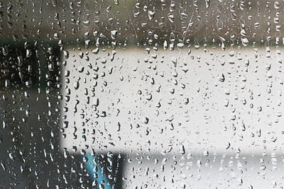 Full frame shot of raindrops on glass window