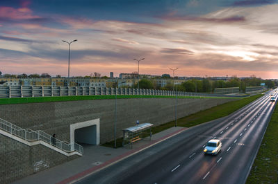 High angle view of cars on street against sky during sunset