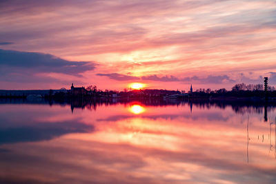 Scenic view of lake against romantic sky at sunset