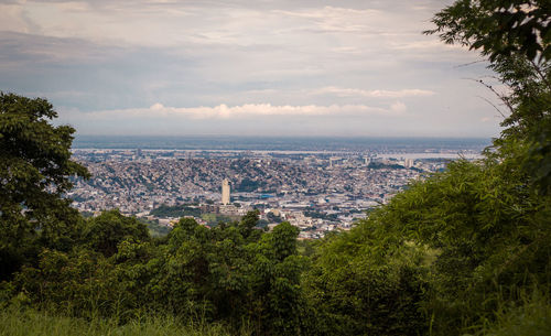 High angle view of city against cloudy sky