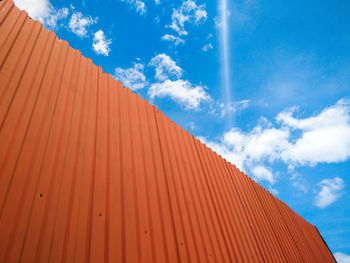 Low angle view of multi colored building against blue sky