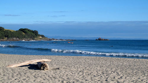 Scenic view of beach against blue sky