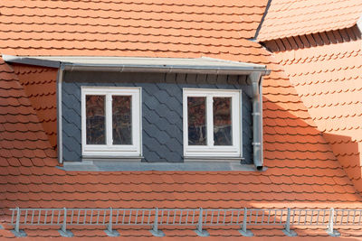 Roof facade with red roof tiles and loft conversion