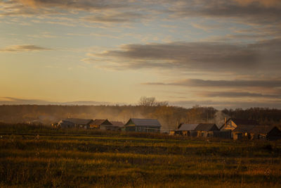 Scenic view of field against sky during sunset