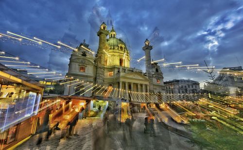 Buildings in city against cloudy sky