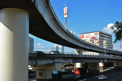 Bridge over road in city against sky