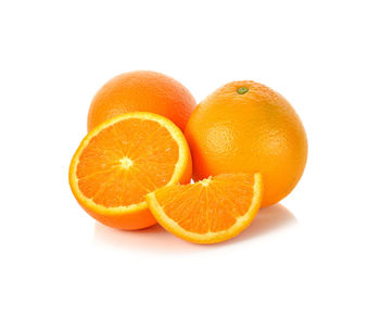 Close-up of orange fruit against white background