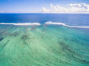 Scenic view of sea against blue sky