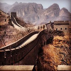 Great wall of china by mountains against sky