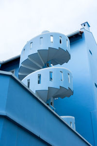 Low angle view of modern building against blue sky