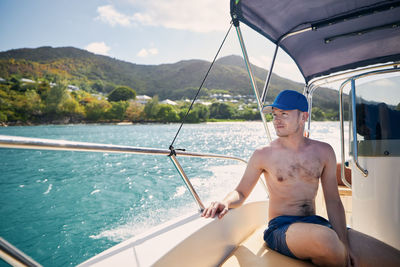 Man sitting on boat in sea