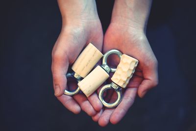 Close-up of hands holding metallic equipment