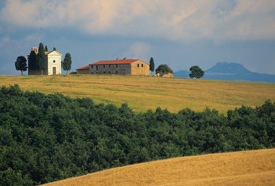 View of castle on field against cloudy sky