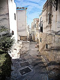 Street amidst buildings against sky