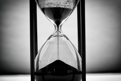 Close-up of clock on glass table