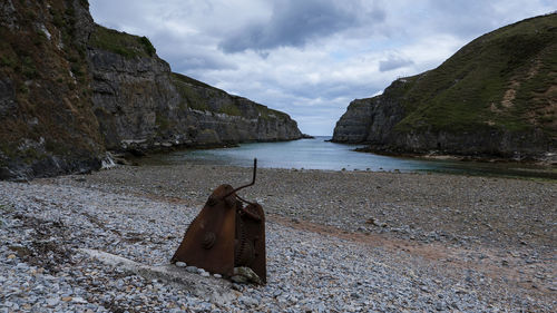 Scenic view of sea and mountains against sky
