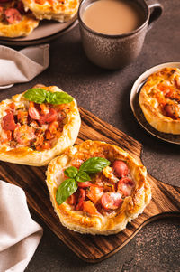 Chicago pizza pot pie with tomatoes, cheese and sausage on a wooden board vertical view