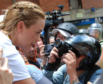 Close-up of photographers photographing mature woman