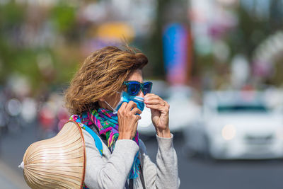 Portrait of woman standing in city