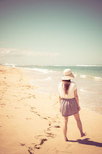 Rear view of man standing on beach