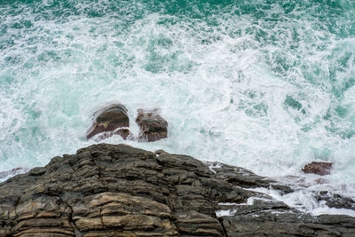 Waves splashing on rocks at shore