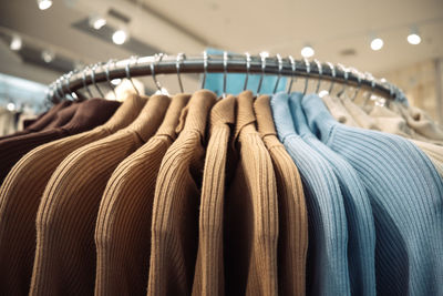 Sweaters hang on a hanger in a semicircle. pastel colors