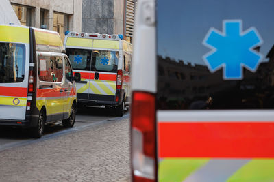 Ambulances on a city street for emergency response.