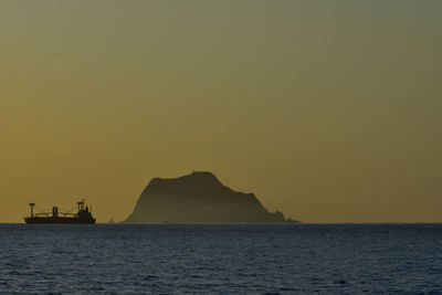 Silhouette of boat sailing in sea