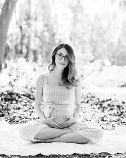 Portrait of young woman sitting outdoors